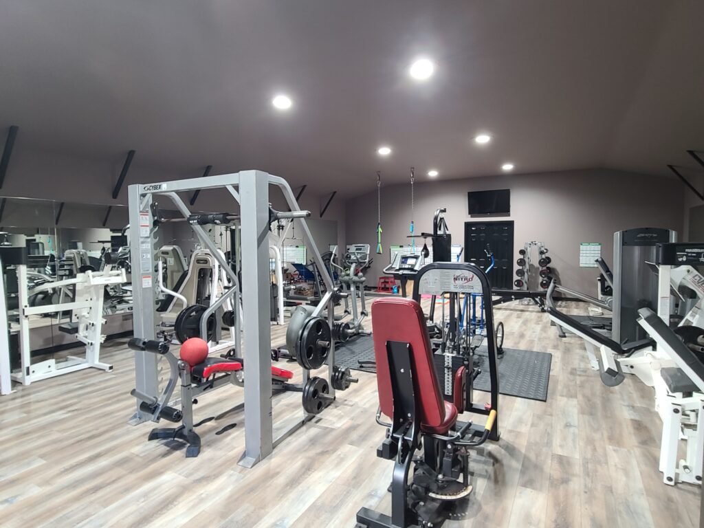 A gym with many different machines and equipment.