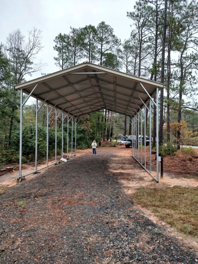 A person riding a bike under a metal structure.