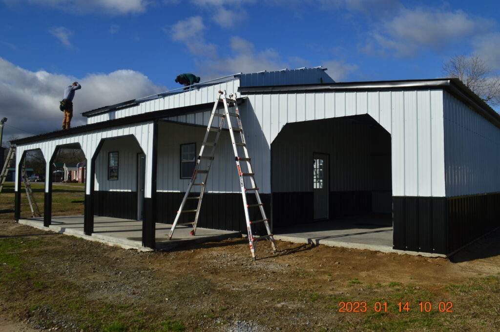 A ladder is in front of a building with solar panels on it.