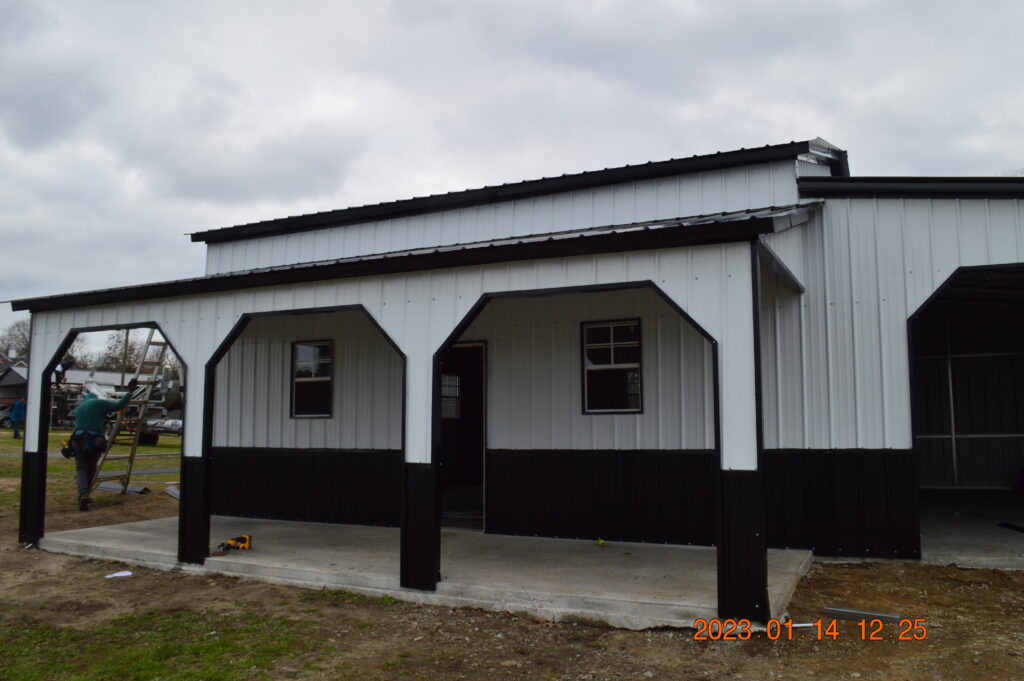 A white and black building with two windows.