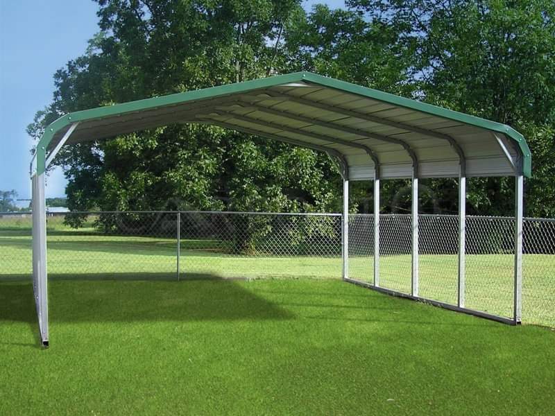 A green and white carport in the middle of a field.