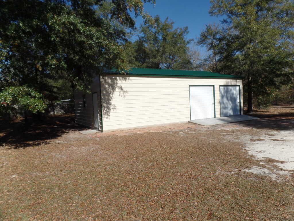 A shed with a green roof and white door.