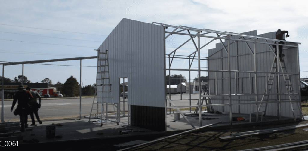 A building being built with scaffolding and metal frame.