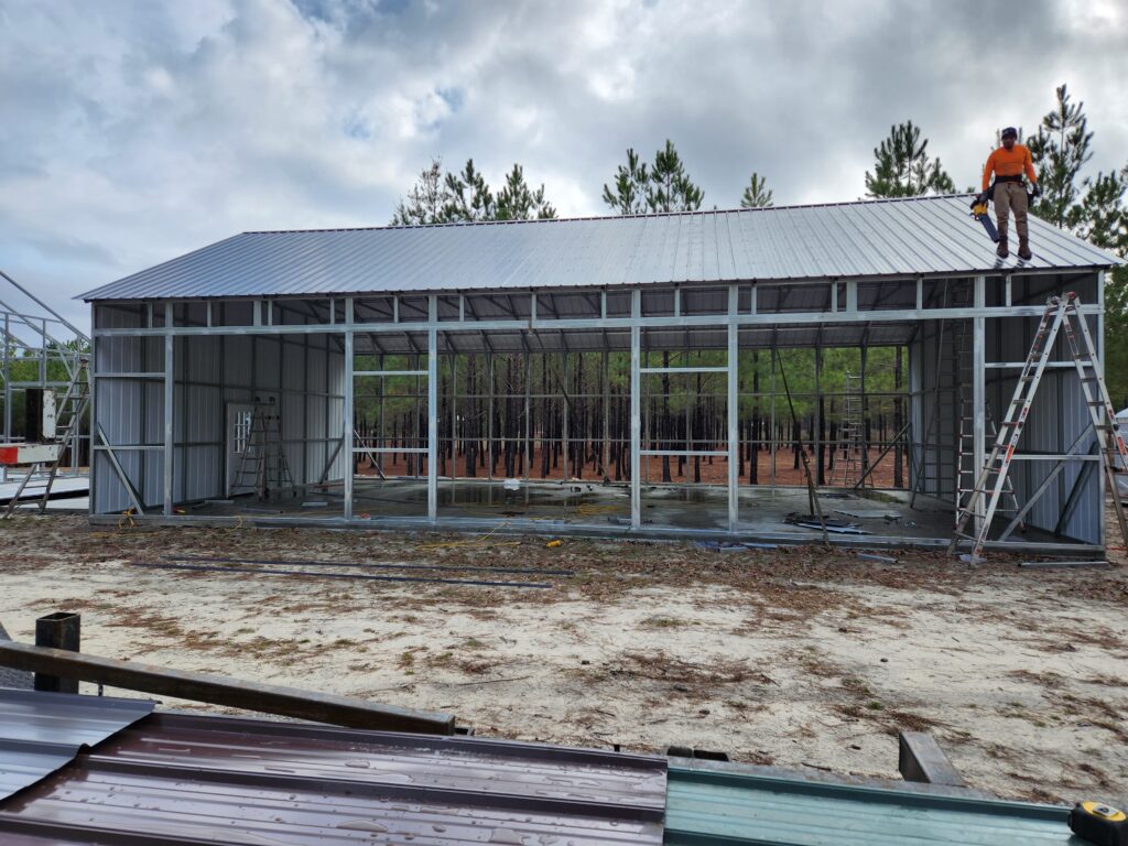 A building under construction with metal roof.