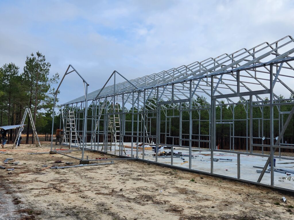 A building under construction with trees in the background.