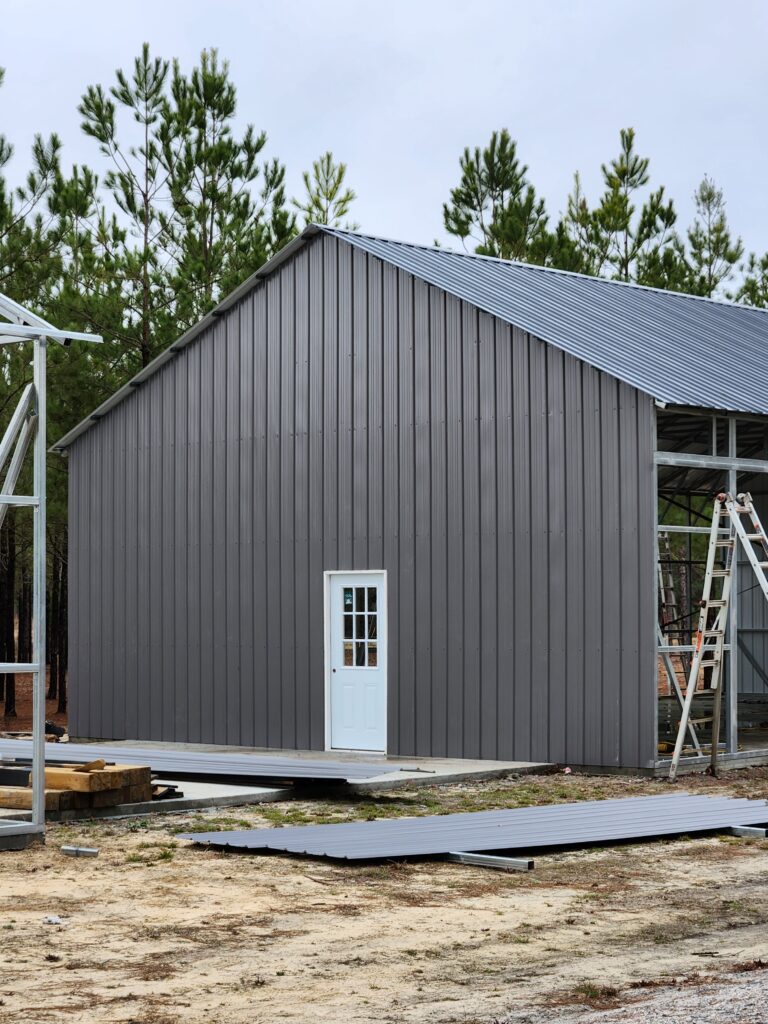 A building that is being built in the dirt.