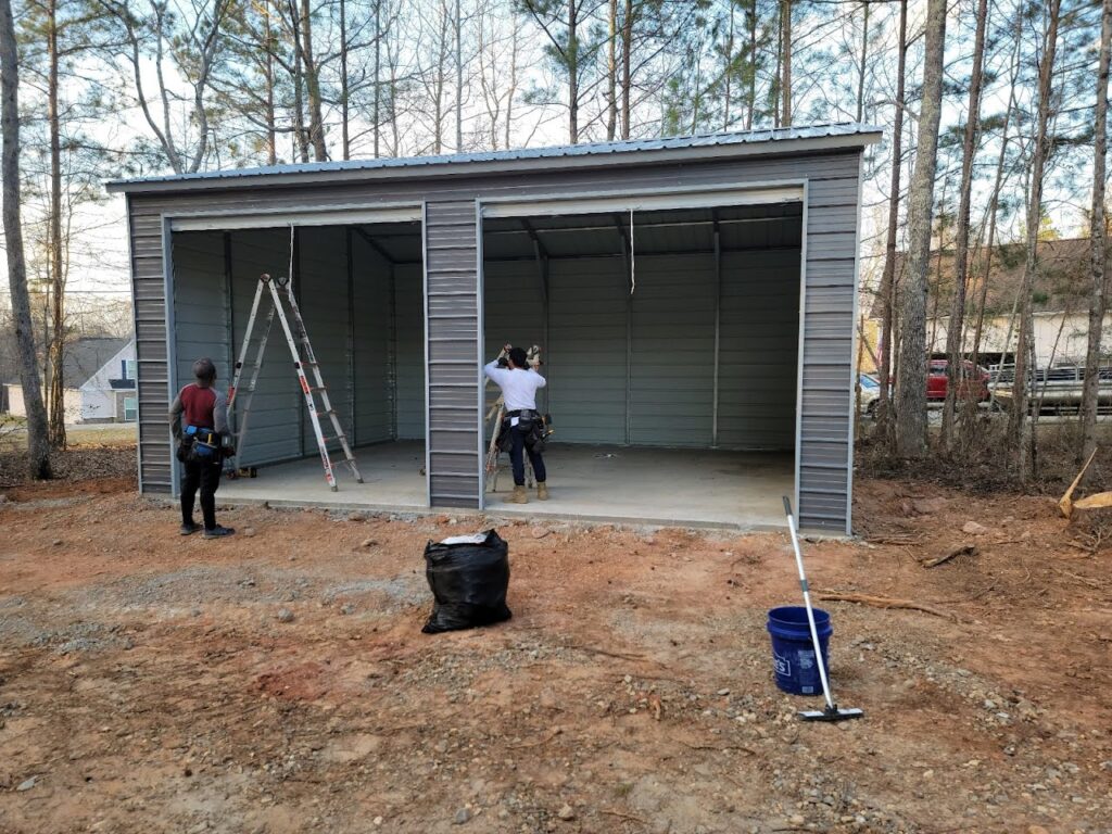 Two men standing in front of a garage.