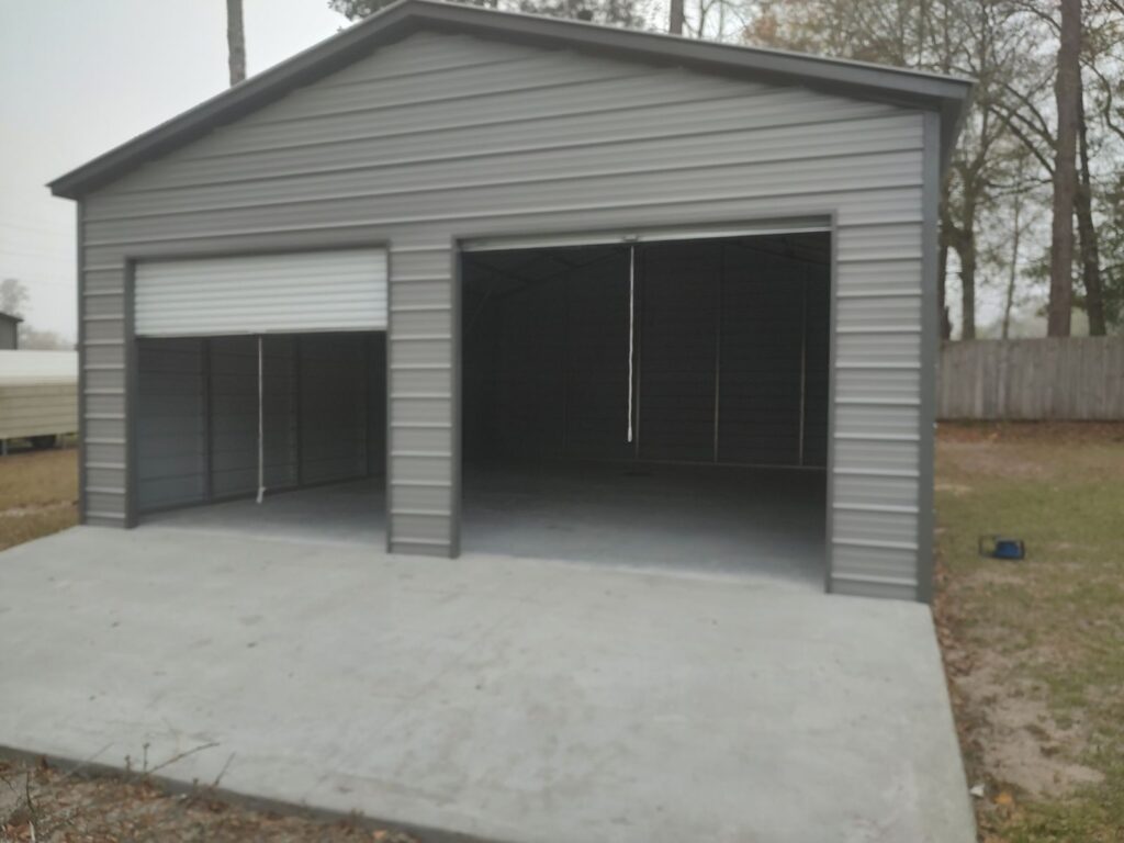 Gray metal building with two open garage doors.